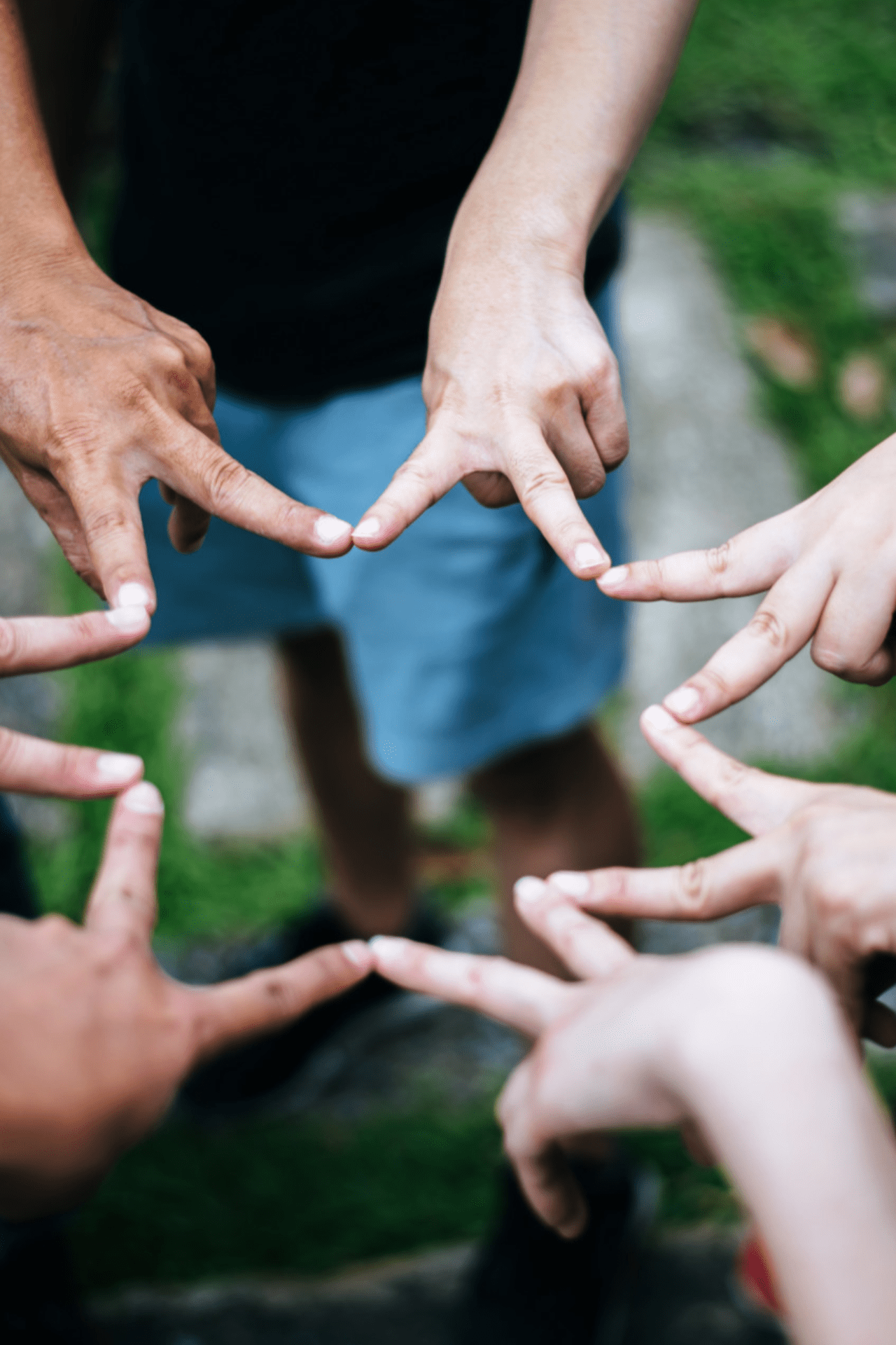Women and men friends make star shape from fingers. Success, friendship concept. Team Members